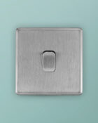 Stainless Steel Arlec Fusion intermediate switch on wall