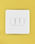 Ice White Arlec Rocker 3 Gang Switch on wall