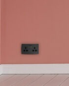Charcoal Grey Arlec Rocker Plug Socket on wall
