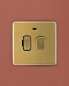 Gold Arlec Fusion fused switch on wall