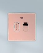 Rose Gold Arlec Fusion switched fused control unit on wall